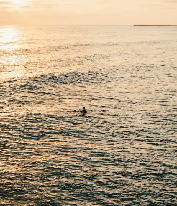 Silhouette of a person meditating with a calm, icy blue background.
